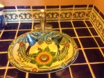Coordinating bird pattern Mexican sink with trim and solid color tile