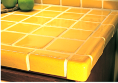 Yellow solid color Mexican tile and trim on bathroom countertop